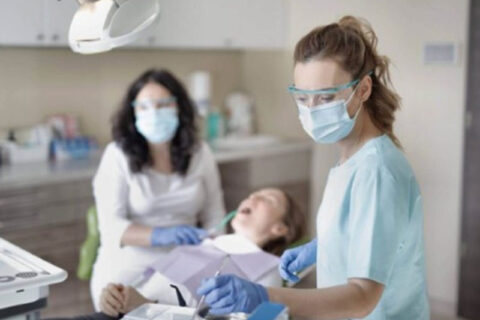Dental professional working with a patient in a dental clinic