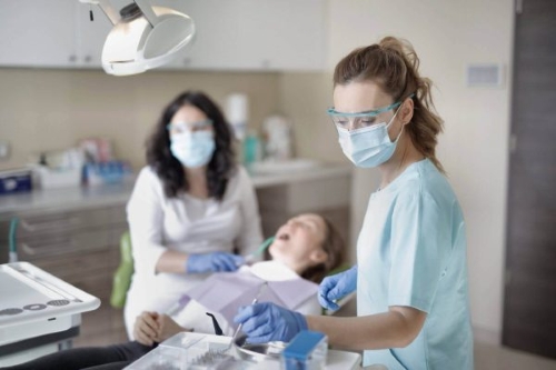 Dental professional working with a patient in a dental clinic