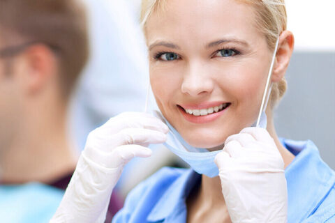 Dental assistant preparing tools in a clinical setting