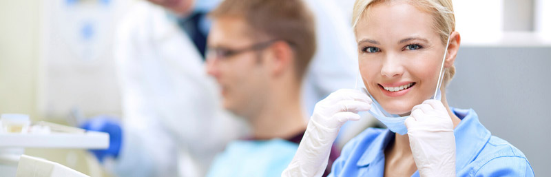 Dental assistant preparing tools in a clinical setting